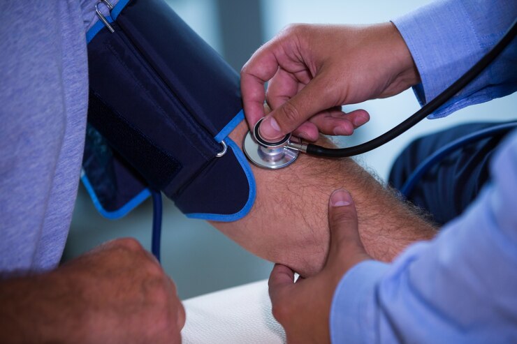 Doctor checking patient blood pressure at Satyam Diagnostics