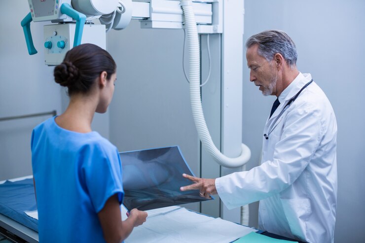 Doctor and nurse discussing an X-ray at Satyam Diagnostics